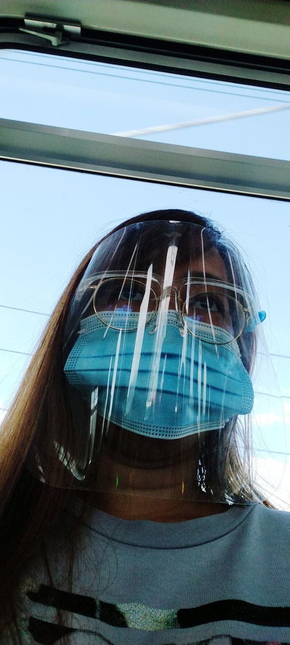 LOW ANGLE VIEW OF WOMAN WEARING SUNGLASSES