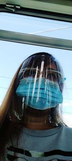 Low angle view of woman on glass window