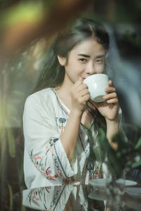 Young woman drinking coffee