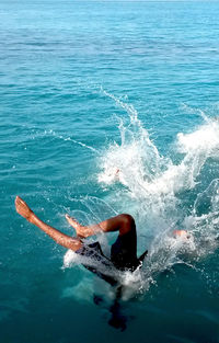 High angle view of man jumping in sea