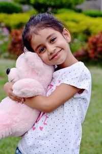 Portrait of smiling girl holding teddy bear