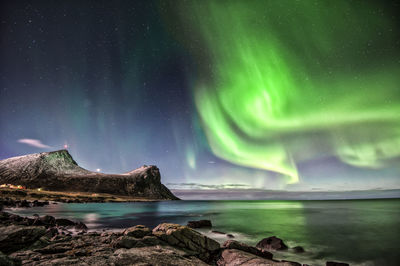 Scenic view of lake against sky at night