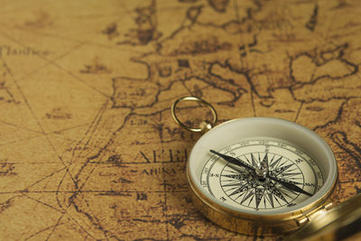 Close-up of compass on map