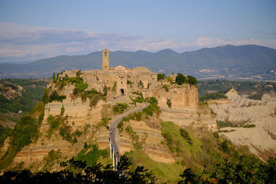 Castle on mountain against sky