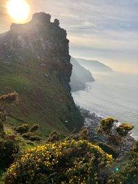 Scenic view of sea and mountains against sky