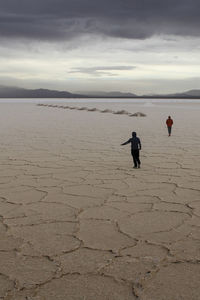 People on beach against sky