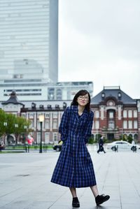 Portrait of woman standing on street