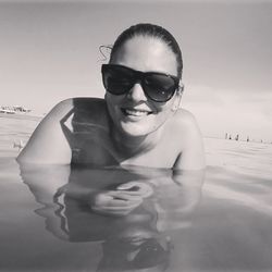 Portrait of young woman in sunglasses at beach