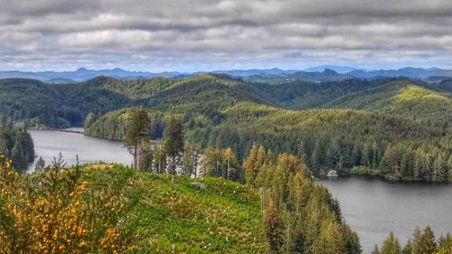 Scenic view of lake and landscape against sky