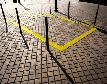 High angle view of yellow shadow on tiled floor