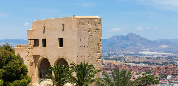 View of castle and buildings against sky