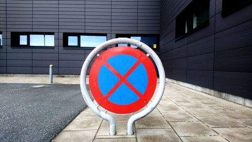 Information sign on road by building