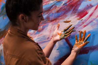 Rear view of woman painting at home