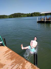 High angle view of shirtless man falling in lake
