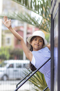 Portrait of smiling woman standing by car