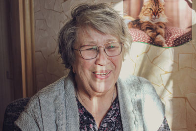 Portrait of smiling old woman at home