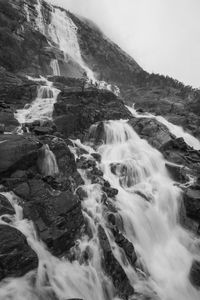 Scenic view of waterfall against sky