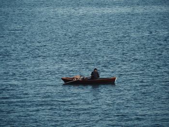 Man in boat sailing on sea