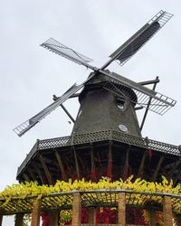 Low angle view of traditional windmill against sky