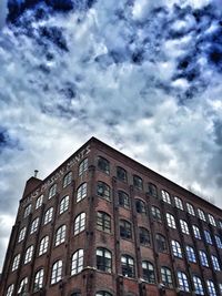 Low angle view of building against cloudy sky