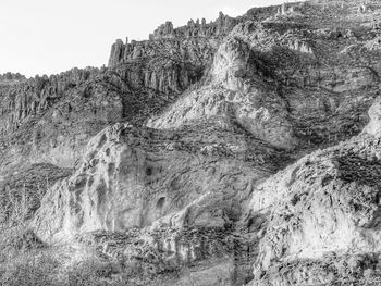 Low angle view of rock formation against clear sky