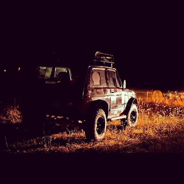 transportation, land vehicle, night, mode of transport, illuminated, field, car, copy space, sky, clear sky, outdoors, no people, stationary, landscape, building exterior, street, built structure, architecture, dark, travel