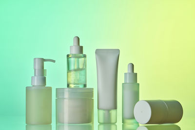 Close-up of bottles against yellow background