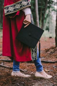 Low section of woman standing on book