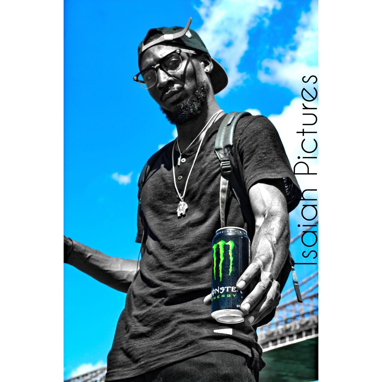 LOW ANGLE VIEW OF YOUNG MAN STANDING AGAINST CLEAR SKY