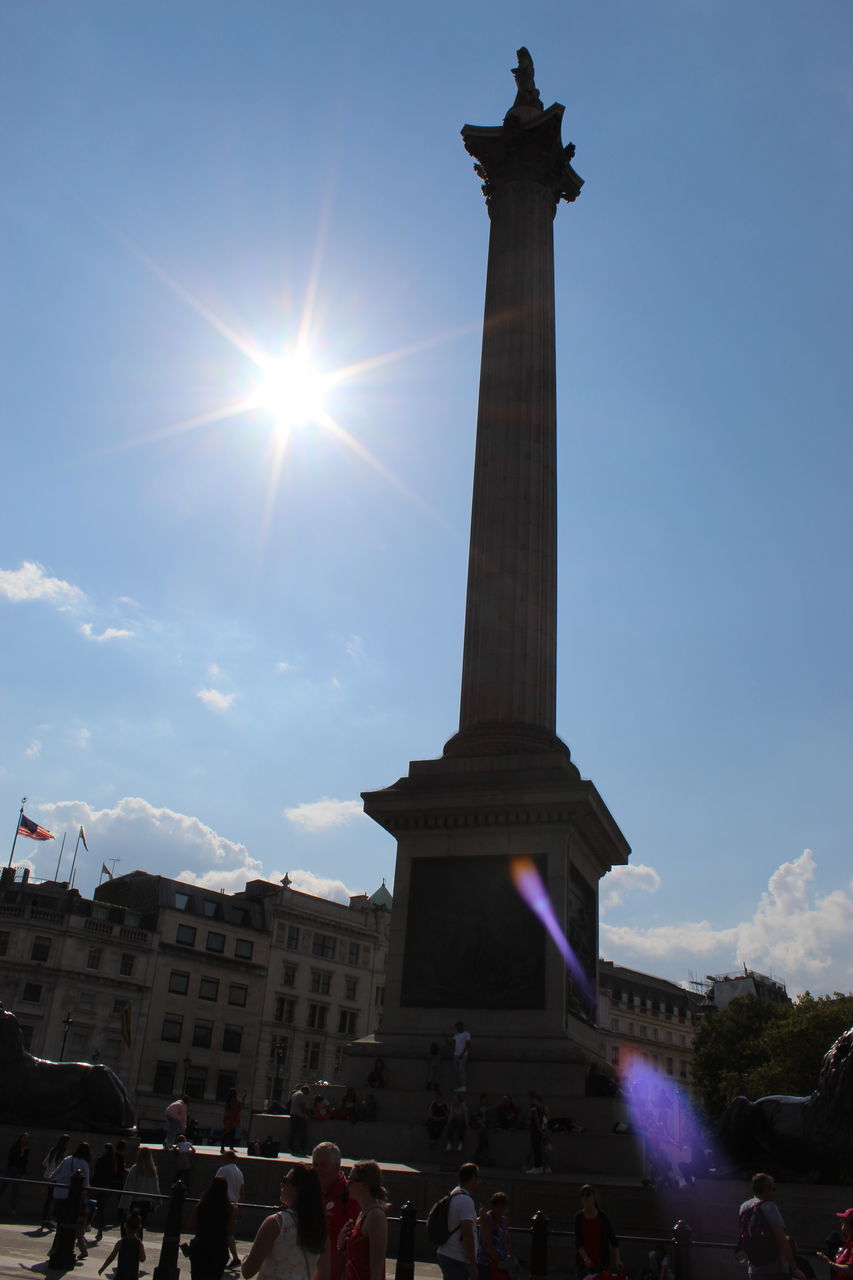 architecture, built structure, travel destinations, sky, crowd, large group of people, history, group of people, tourism, the past, travel, city, building exterior, nature, memorial, sunlight, sun, real people, monument, lens flare, tall - high, architectural column