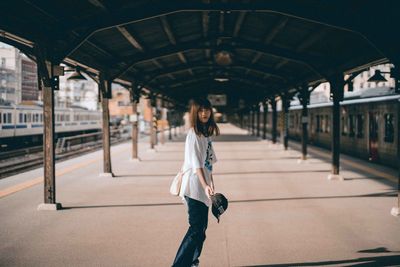 Full length of woman on railroad station