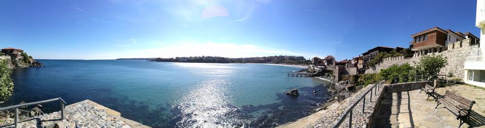 Panoramic view of bay against blue sky