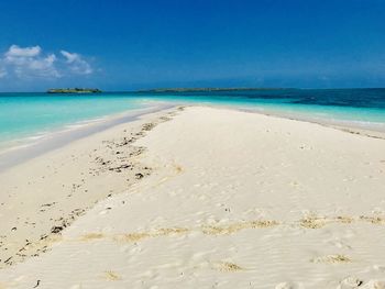 Scenic view of beach against blue sky