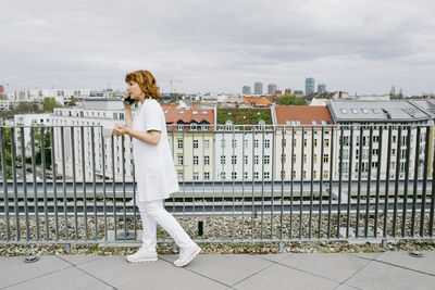 Full length side view of senior female doctor talking to mobile phone