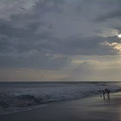 Scenic view of sea against cloudy sky