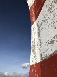 Low angle view of flag against blue sky