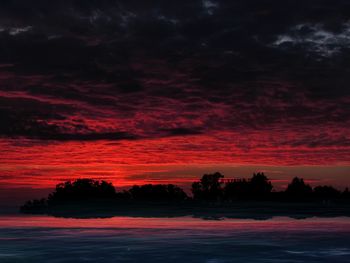 Scenic view of lake against romantic sky at sunset