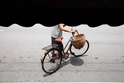 High angle view of man with bicycle on road