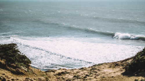 High angle view of waves splashing at beach