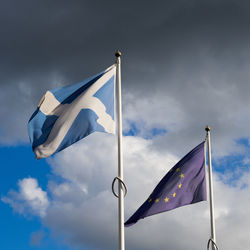 Low angle view of flag against sky