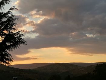 Scenic view of silhouette mountains against sky at sunset