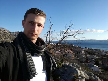 Man standing on mountain against sky