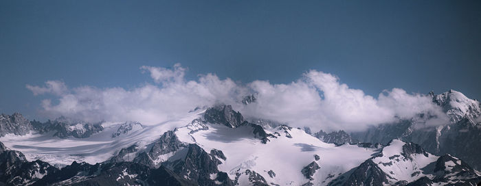 Panoramic view of snowcapped mountains against sky