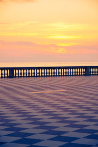 Pier over sea against sky during sunset