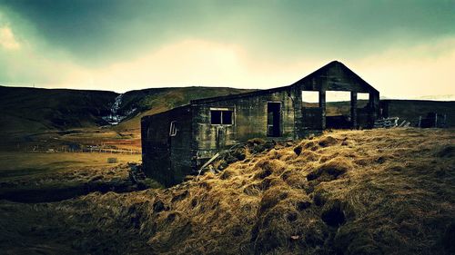 Houses against cloudy sky