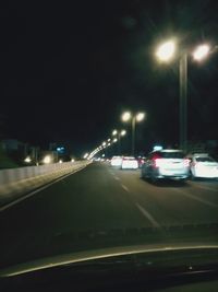 Cars on road in city at night