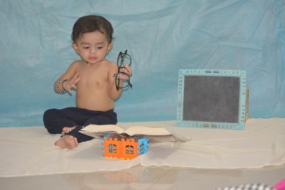 Cute boy playing with toy at home