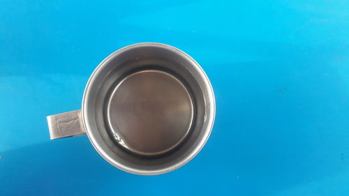 High angle view of black coffee on blue table