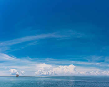 Scenic view of sea against blue sky