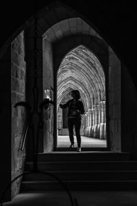 Rear view of people walking in corridor of building